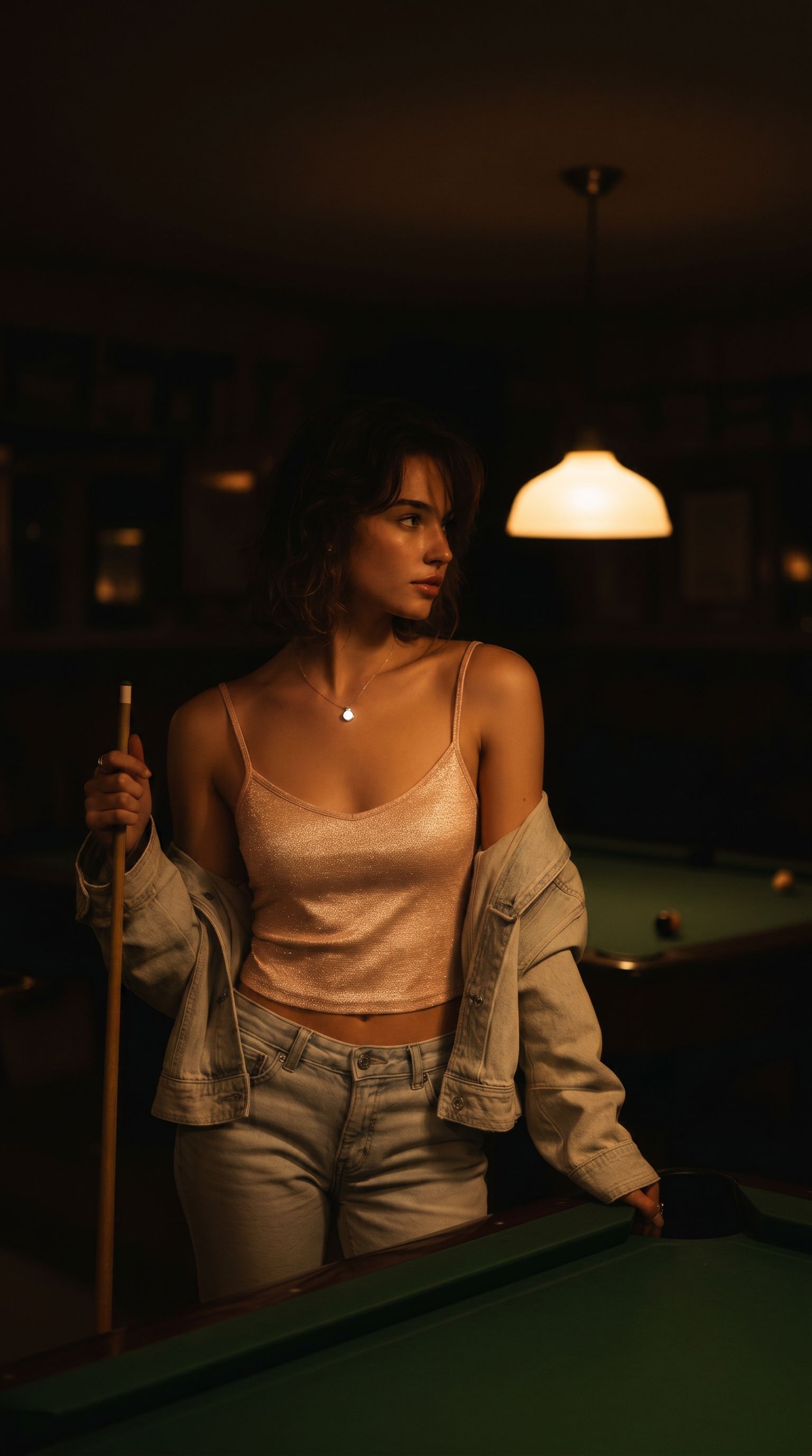 Louis Jacques self-illuminating sterling silver necklace worn by model under pendant light in warm pool bar.