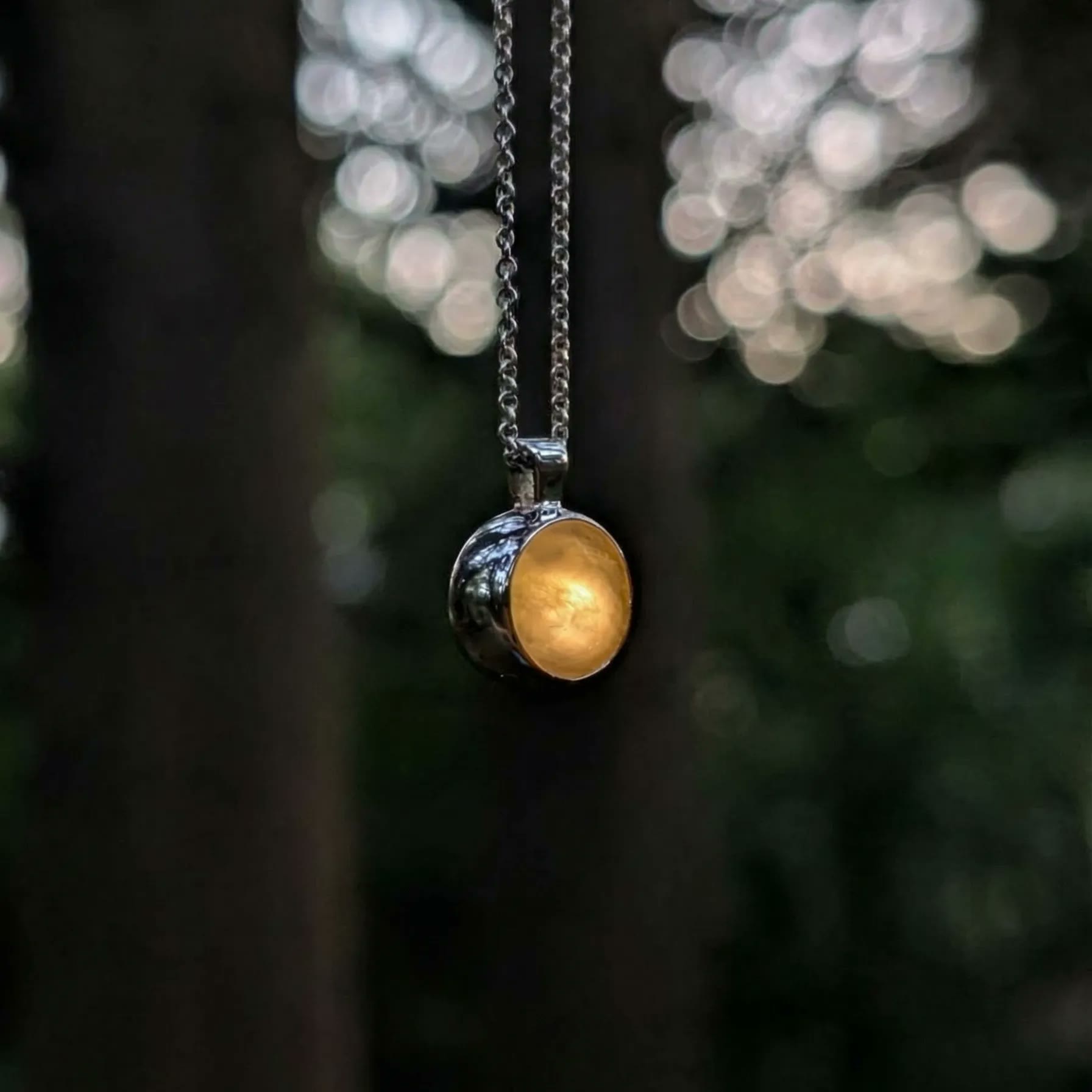 Louis Jacques pendant, angled view between trees